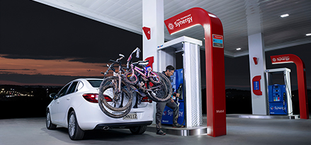 White car with bikes at Synergy fuels pump