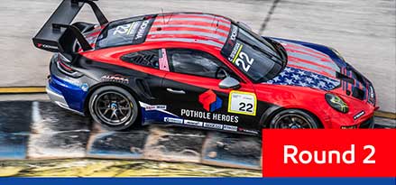 Red and black Porsche Carrera racing at the Miami international Autodrome