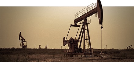 Oil rig on flat land at night